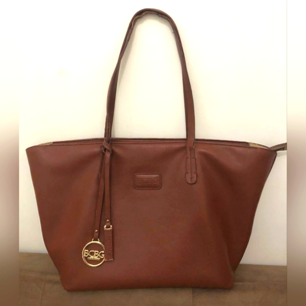 BCBG Paris Tan Tote with Gold Logo and Shoulder Straps and Zipper enclosure.